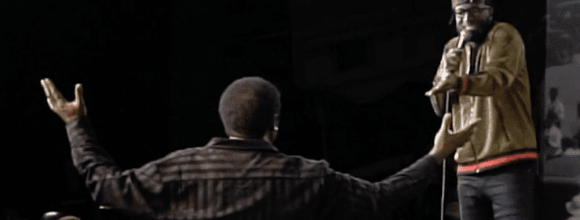 Two men on stage during a performance.